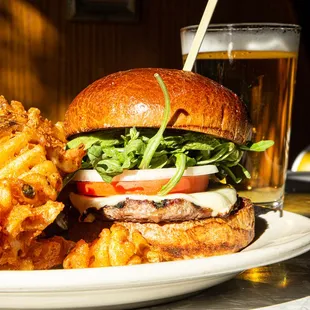 a plate of food and a glass of beer