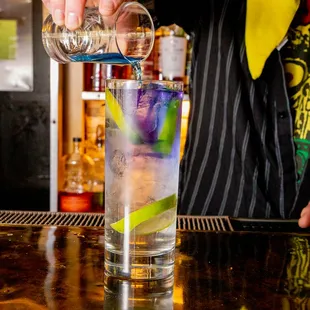 a bartender pouring a drink at a bar