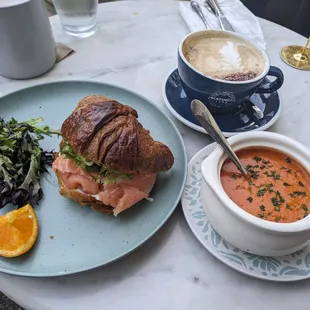 a croissant sandwich and soup