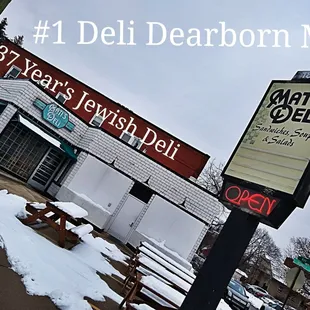 a sign in front of a deli