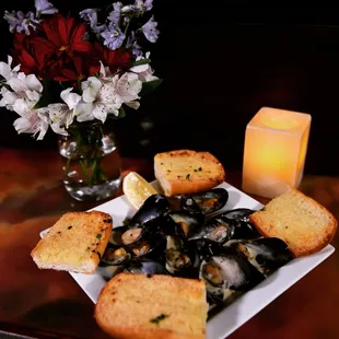 a plate of mussels and bread