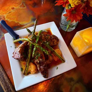 surf &amp; turf. frenched rosemary double lamb chops &amp; tiger shrimp, spicy guajillo sauce.