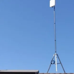 Building with tripod and antenna.