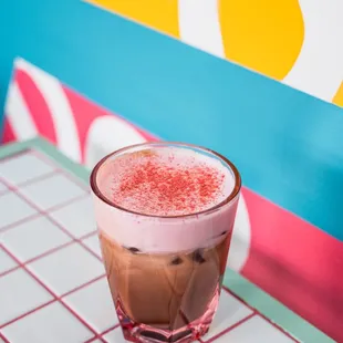 a glass of coffee on a table