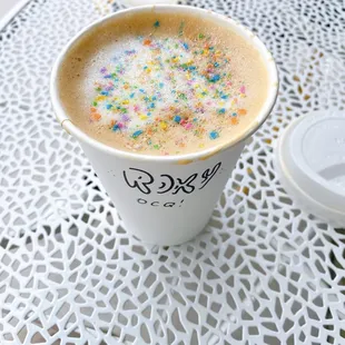 a cup of coffee with sprinkles