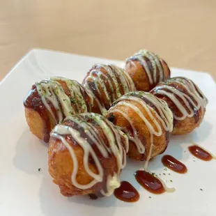 Takoyaki.  Octopus dumplings served with sweet and savory sauce