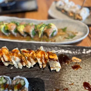 a plate of sushi and rolls