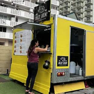 a woman opening a food truck