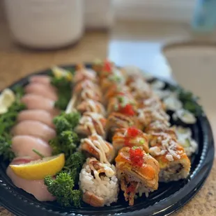 a plate of sushi and vegetables