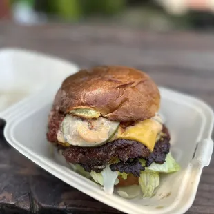 a burger in a styrofoam container