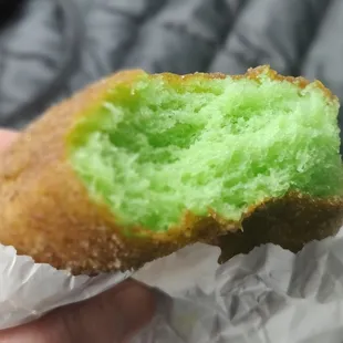 Pandan doughnut dipped in cinnamon.