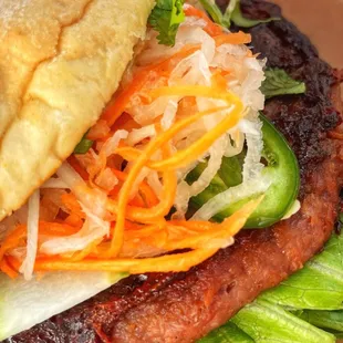 Beyond Mi Burger with pickled carrots and daikon, cucumbers, jalapenos, cilantro, lettuce, vegan aioli on a sesame bun $16.00