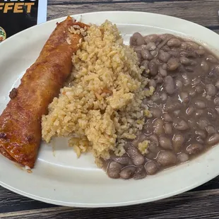 Red enchilada with cheese, rice, and beans entrée