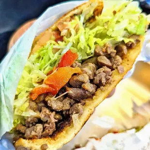 a sandwich with meat and lettuce
