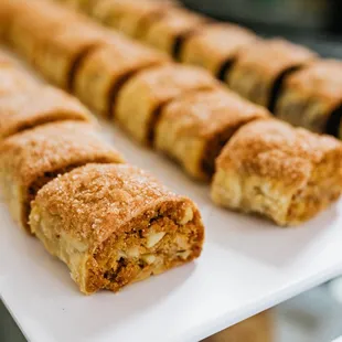 a row of pastries on a white plate