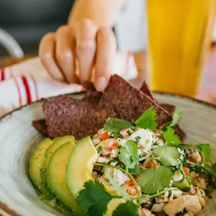 a plate of food and a glass of beer