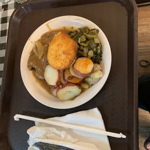 Country fried steak, turnip greens, potatoes, muffin.