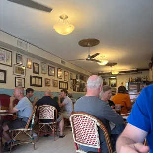 people sitting at tables in a restaurant