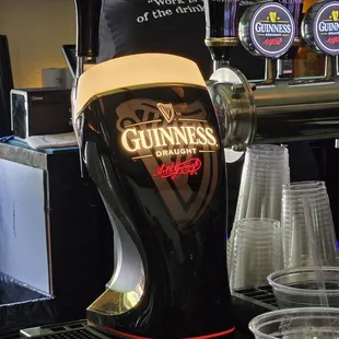a guinness beer being poured