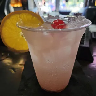 a pink drink with a garnish