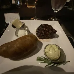 Steak with baked potato. Served with a garlic butter, regular butter and sour cream.