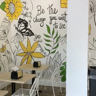 a dining room with a painted wall