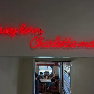 a neon sign that reads texas born charlotte