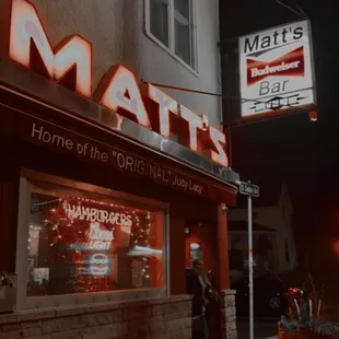 a man standing in front of a restaurant