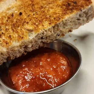 a grilled cheese sandwich with tomato sauce