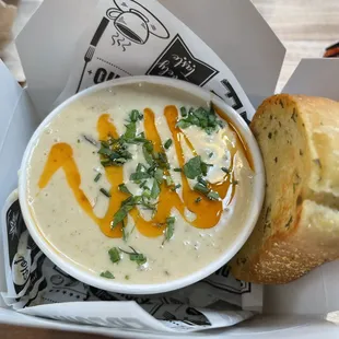 a bowl of soup and a roll