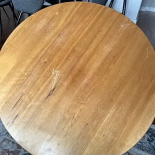 cherry wood coffee table. Scratched and gouged, leg snapped.