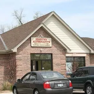 two cars parked in front of a building