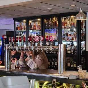 Part of the bar area with large display case of whiskeys and bourbons