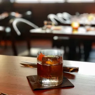 Matu Old Fashioned with bourbon, maple syrup, bitters, and a burnt orange peel