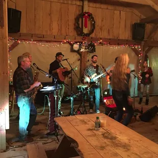 a band playing in a barn