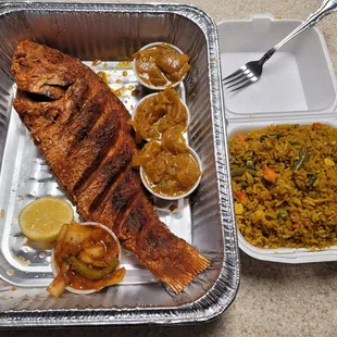 Large red snapper yassa and jollof rice(I think).