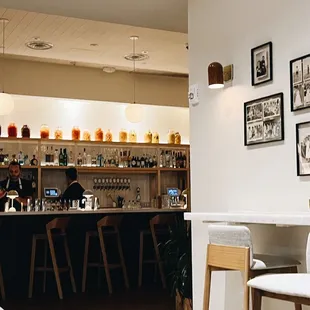 a bar with stools and pictures on the wall