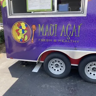a purple food truck parked in a parking lot
