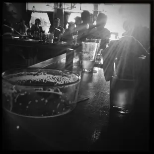 a black and white photo of a bar