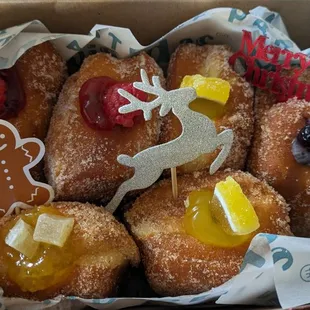 a box of doughnuts with various toppings