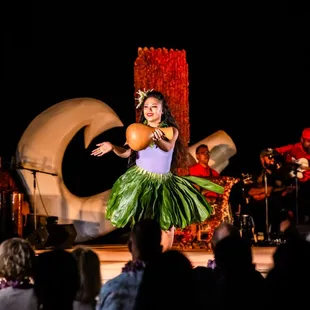 A hula performer enchants the audience before the majestic throne of King Kamehameha