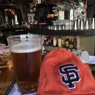 a baseball cap and a glass of beer