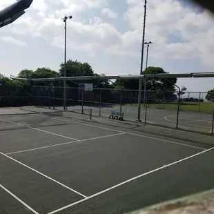 Tennis court and basketball court (with intact rims)