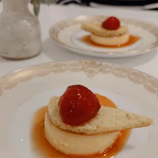 a plate of dessert with a strawberry on top