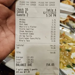 a hand holding a receipt