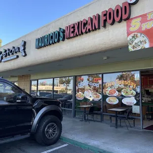 a truck parked in front of a restaurant