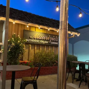 a patio with tables and chairs