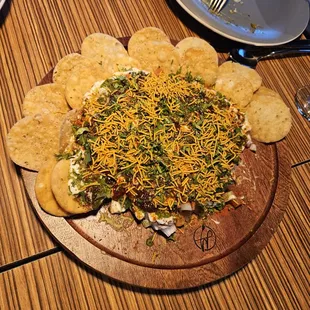 Papdi Chaat - Crispy fried dough wafers topped with potatoes, yogurt, and chutneys