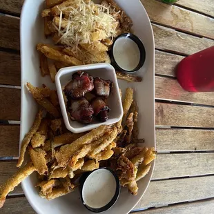 Appetizers Sampler Platter with Garlic Parmesan Fries, Pickles Fried and Bacon Wrapped Poppers.