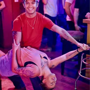 a man and a woman doing a handstand